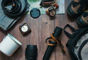 Camping gear on a wooden background